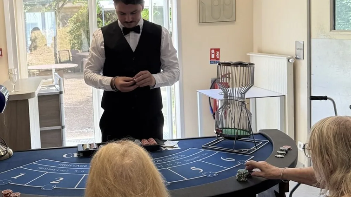 Table de Chuck-a-Luck et sa cage à dés rotative, animée par un croupier lors de la journée casino en EHPAD